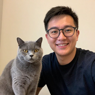 Sam Okafor sitting next to a large grey cat
